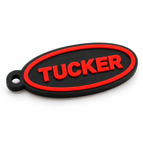 Digital product render of black oval keychain with raised red TUCKER name